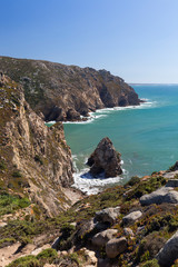 Scenic view of Atlantic Ocean and rugged coast at Cabo da Roca, the westernmost point of continental Europe, in Portugal, on a sunny day.