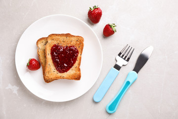 Flat lay composition of toasts with jam on light grey marble table. Breakfast for kids