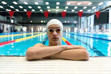 Portrait of a swimmer on the background of the pool.