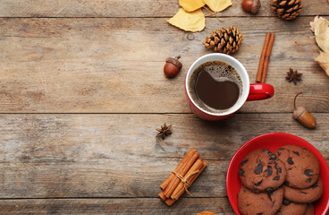 Flat lay composition with cup of hot drink on wooden table, space for text. Cozy autumn atmosphere