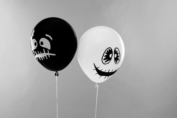 Spooky balloons for Halloween party on light grey background