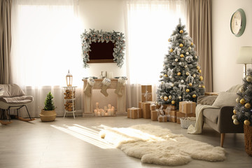 Stylish Christmas interior with beautiful decorated tree and fireplace