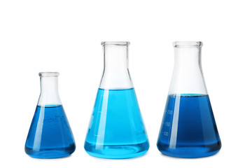 Laboratory glassware with blue liquids isolated on white