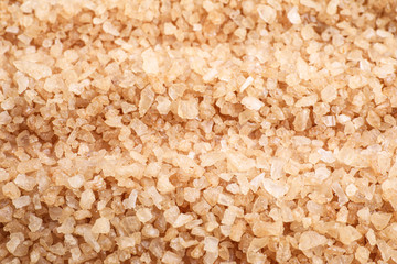 Brown sea salt as background, closeup. Spa treatment