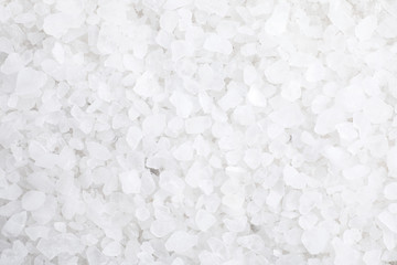 White sea salt as background, top view. Spa treatment