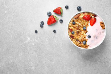 Tasty homemade granola  served on grey table, flat lay with space for text. Healthy breakfast