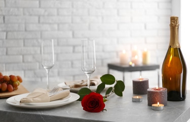 Romantic table setting with burning candles indoors