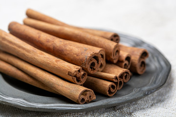 Winter food ingredient, dried aromatic cinnamon sticks on tin plate