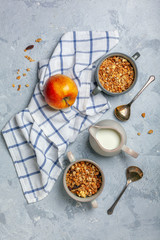 Granola in bowls and a jug of milk for breakfast.