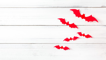 Halloween red bats flying horror on white wood background, decoration concept.