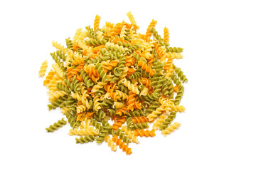 Fusilli tricolore raw dry pasta pile isolated on white
