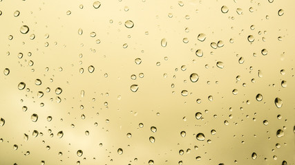 Yellow background with drops on a surface