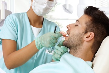 Obraz premium Young man at dental surgeon