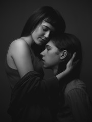Young woman and young man hugging. Black and white