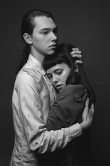 Young couple hugging in studio. Black and white