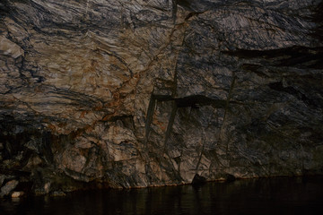 Underground Grotto Panorama.Types of a former underground marble quarry flooded with water. The massive arches of the grotto and the texture of natural marble are visible. Russia, Karelia, Ruskeala