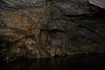 Underground Grotto Panorama.Types of a former underground marble quarry flooded with water. The massive arches of the grotto and the texture of natural marble are visible. Russia, Karelia, Ruskeala