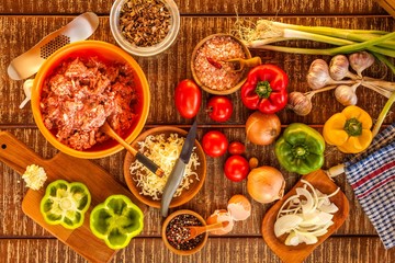 Raw minced meat. Preparation of stuffed peppers. Homemade food preparation. Vegetables and minced meat.