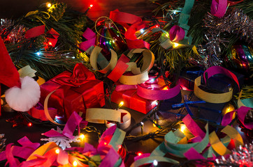 Christmas and New Year's gifts with tinsel, garlands, coniferous branches. Bright Christmas and New Year background.