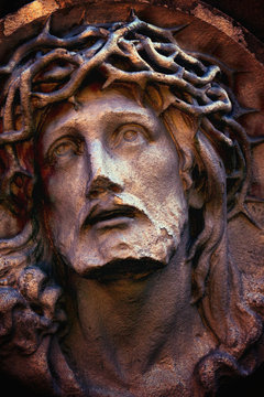 Dramatic image of ancient statue of Jesus Christ crown of thorns