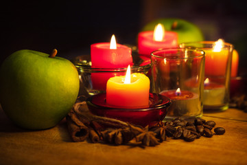 apple with cinnamon, coffee beans, star anise and a candles