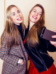 Fototapeta na wymiar lifestyle and people concept: Fashion portrait of two stylish girls best friends, over white background. Happy time for fun