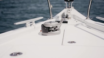 Close up of nautical anchor winch and chain on a luxury super yacht.