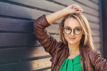 Beautiful young woman smiling with a new pair of eyeglasses - Outdoor autumn portrait