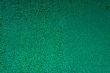 Green painted wooden surface with a rough texture