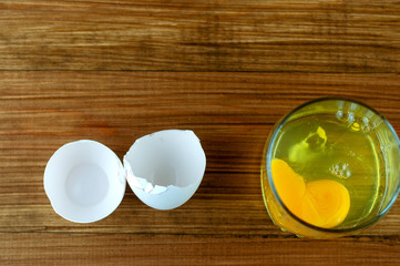 raw egg white in a glass with yolk, top view