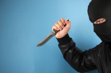 the masked man  knife in his hand