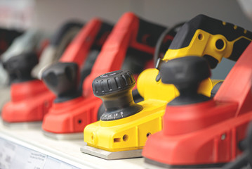 Fototapeta premium Various new electric planers on construction store counter.