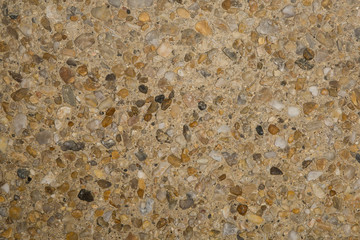 Gros plan texture béton désactivé avec graviers gris, noir et couleur