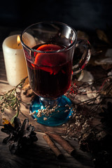 Glass of glintwein close up, rustic style, dark photo