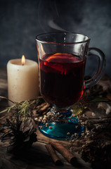 Glass of glintwein close up, rustic style, dark photo