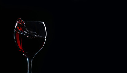 glass of red wine on a dark background