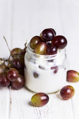blanmange with cottage cheese, milk, gelatin and grapes in a glass jar