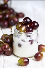 blanmange with cottage cheese, milk, gelatin and grapes in a glass jar
