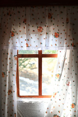 Floral curtains in rustic hut