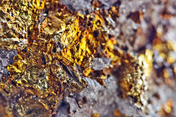 Golden background. Nugget, colour metal. Beautiful structure. Macro