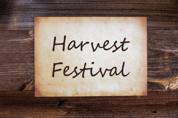 Old Grungy Paper With English Text Harvest Festival. Wooden Background