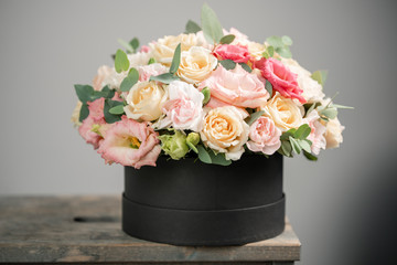 Beautiful bouquet of mixed flowers in round box. the work of the florist at a flower shop. Fresh cut flower.