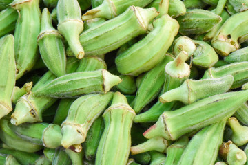 Fresh okra vegetable in bazaar, closeup, isolated.