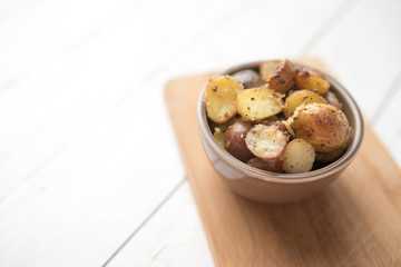 Delicious Roasted mini potato with spices and Parmesan cheese, cut in halves