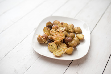 Delicious Roasted mini potato with spices and Parmesan cheese, cut in halves