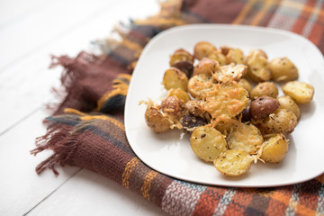 Delicious Roasted mini potato with spices and Parmesan cheese, cut in halves