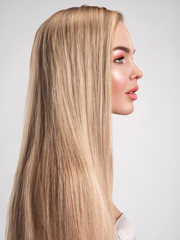 Portrait of a blonde beautiful woman with a long straight light hair. Portrait of a beautiful woman with a coral color makeup. Beautiful female face. Fashion model.