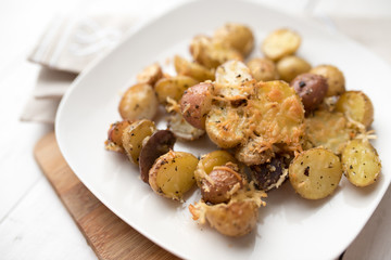 Delicious Roasted mini potato with spices and Parmesan cheese, cut in halves