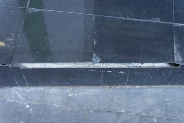 Fototapeta premium Close Up of cracked ceramic tiles on a stairs surface.