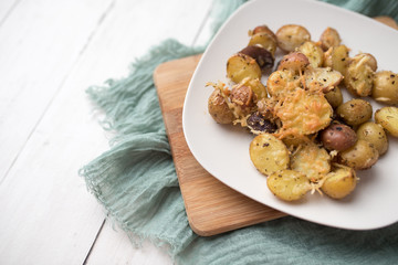 Delicious Roasted mini potato with spices and Parmesan cheese, cut in halves